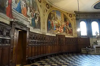 Disambulatory with wood carvings from stalls of St. Vaste Abbey (17th c.)