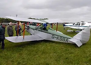 A drooped elevator, nearly touching the grass, on the horizontal stabilizer of this Currie Wot biplane