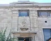 Architectural detail above side entrance, including carved capitals and amphora