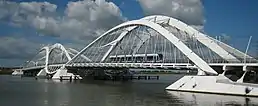 A tram crossing a curved double span bridge.