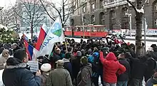 Organisers with media crew in front of the building of the government of Serbia on 12 January 2022