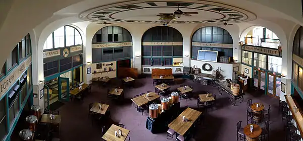 Large, octagonal room with several, square tables surrounded with chairs