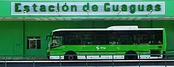 A bus in front of a bus station.