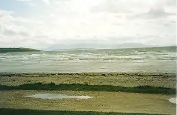 Looking south over a stormy Ettrick Bay. The island of Arran is visible in the distance