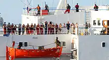 Image 69The crew of the merchant vessel Faina stand on the deck after a U.S. Navy request to check on their health and welfare. The Belize-flagged cargo ship owned and operated by Kaalbye Shipping, Ukraine, was seized by pirates 25 September 2008 and forced to proceed to anchorage off the Somali Coast. The ship is carrying a cargo of Ukrainian T-72 tanks and related military equipment. (from Piracy off the coast of Somalia)