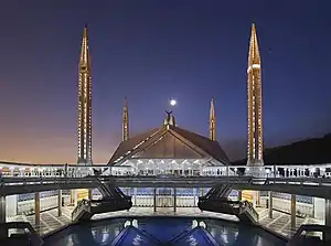 Image 6The Faisal Mosque (Urdu: فیصل مسجد) is a mosque located in Islamabad, Pakistan. It is Located on the foothills of Margalla Hills in Islamabad, the mosque features a contemporary design consisting of eight sides of concrete shell and is inspired by a Bedouin tent, and is considered to be the city's main Landmark.US Department of Defense (edited by Jjron)