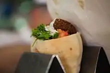 Falafel stuffed in pita with Israeli salad