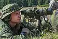 Spotter from a sniper team observing targets.