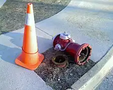 A fire hydrant that was hit by a snow plow and knocked over, damaging only the  sacrificial bolts