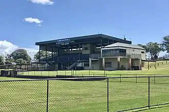 Sports stand viewed from afar, with grass in foreground