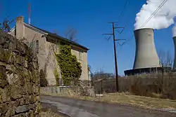 An abandoned house in Fricks Locks Historic District (foreground) and Limerick Generating Station (background)