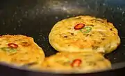 Korean mung bean pancakes being cooked