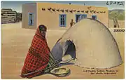 Puebloan woman at her adobe bake-oven