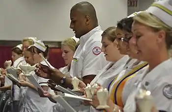 Nursing student graduate (center) participates in the reading of the International Nurses' Pledge during Germanna Community College's Nursing and Health Technologies convocation, held at the Fredericksburg Expo and Conference Center in Fredericksburg, Virginia, USA.