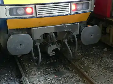 "Drophead" coupler swung down reveals buffers and chain coupler on a British Rail Class 91.