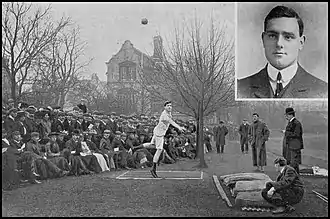 outdoor scene with spectators watching a young white man putting the shot