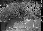 Geilston Bay, Tasmania, aerial photograph 26 Mar 1946. Note the overall lack of development, with the orchard (right of centre) and flooded former limestone quarry workings below.