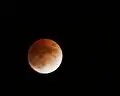 During a lunar eclipse, the Moon is colored red by indirect sunlight, which Earth's atmosphere has scattered and refracted.