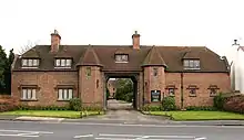 A redbrick building with a road through the centre