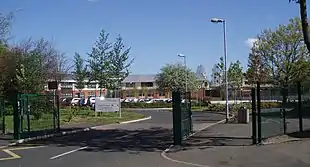 A modern two-storey school building at the end of a drive