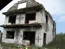 Bosnian Croat house defaced with graffiti: Serbian cross, "Red Star champion", "Usraše se Ustaše" (Ustashas shat their pants) and "God protects Serbs"