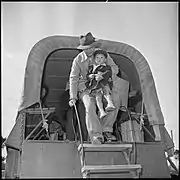 Granada Relocation Center internees arrive by truck to board trains taking them to California and elsewhere