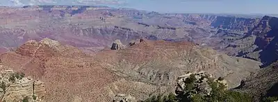 Wide canyon with exposed red- and tan-colored rock