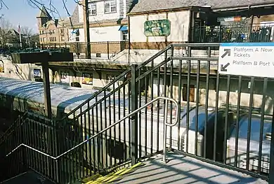 A Port Washington-bound train at the station, as seen from a staircase to Platform B.