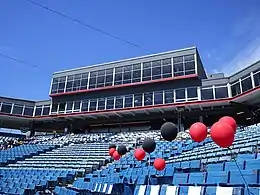 A view of the concourse behind home plate. Overlooking the field are sky boxes and the press box on the third floor and the fourth floor stadium restaurant, all of which are fronted by glass windows.