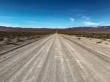 a dirt road leading off towards the horizon