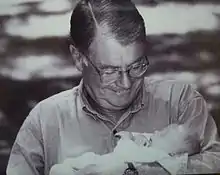 Image of Gunnar Stickler holding his granddaughter