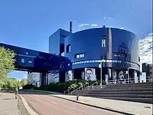 Midnight blue modern building seen from green area