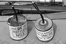 Trench improvised explosive device in a milk tin and a similar manufactured double cylinder grenade (A Great War Society munition)