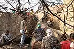 Enthusiasts crowd a rock formation