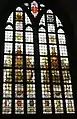 Stained glass window in the church donated by A.J. Enschedé with Laurens Janszoon Coster on the left and a typesetter's workshop on the right.