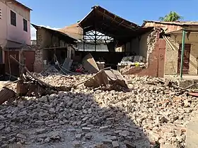 Damage to a building. Rubble strewn all over.