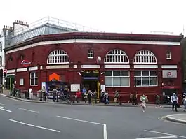 Terracotta railway station building at the bottom of a hill