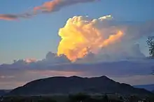 A cloud appears to be set in place by a human hand