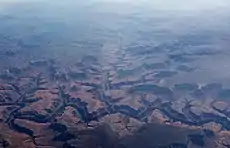 Oblique air photo of the canyon of Havasu Creek flowing into the Colorado River in the foreground