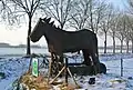 Wooden horse in the pasture