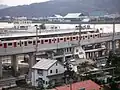 A distant view of the station with the Matsuura River in the background.