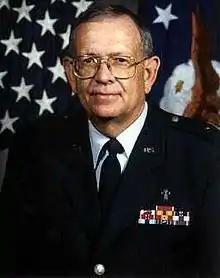 A portrait photo of a Caucasoid man in military uniform and spectacles; he is facing the camera, though looking just to its left.