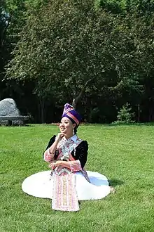 White Hmong woman - Wearing a white skirt from the white Hmong group.