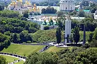 Memorial to Holodomor victims with Kyiv Pechersk Lavra in the background