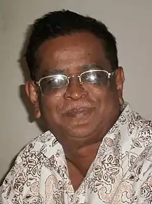 Face of a middle-aged man, spectacles, smiling