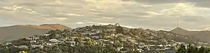 Huntsbury viewed from neighbouring St Martins. Also shown are the landmarks of Mt Vernon on the left and Te Heru o Kahukura / Sugarloaf and its transmitter on the right.