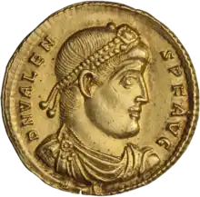 Golden coin depicting man with diadem facing right