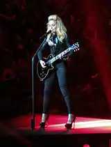 Madonna playing a guitar