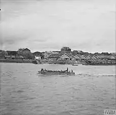 Indian landing craft enters Rangoon harbour to crowds of cheering civilians