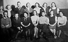 Photograph of 14 young adults arranged in two rows of seven people.